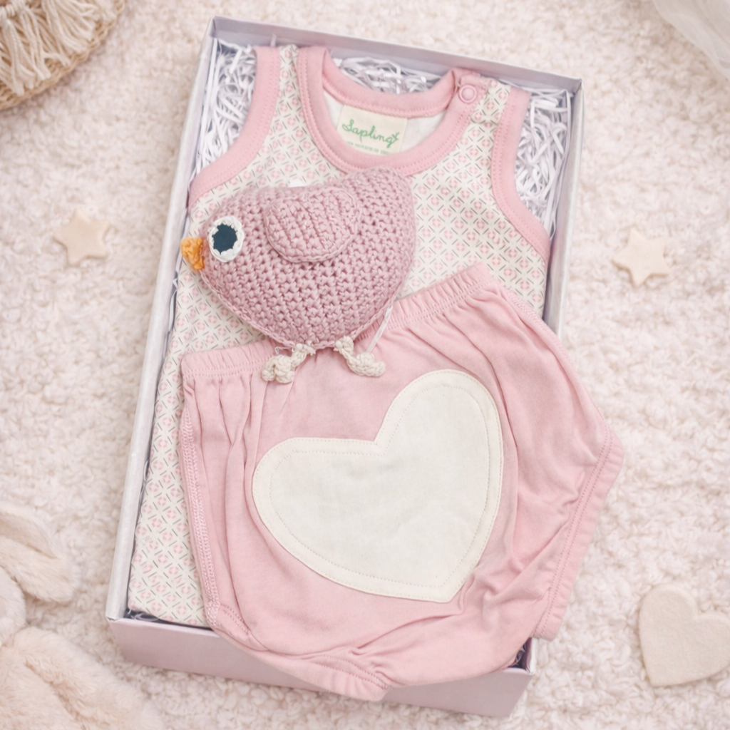 little rosebud baby girl gift box with pink baby outfit bloomers and knitted bird rattle